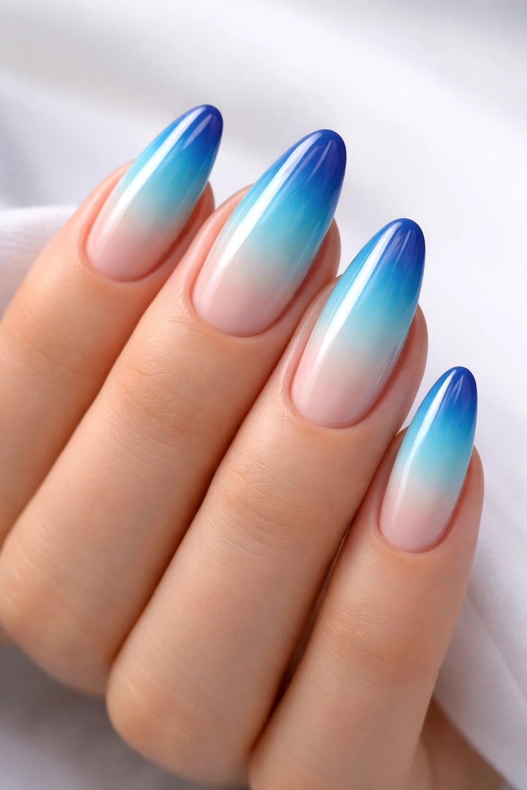 Blue to turquoise ombre French tips on nude base nails