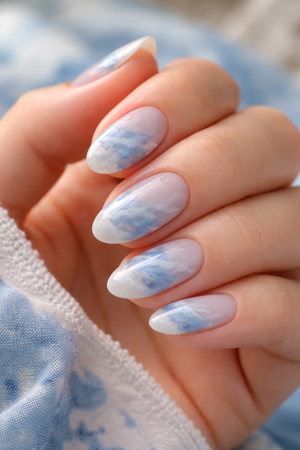 Blue watercolor nails on short almond nails with layered blue tones