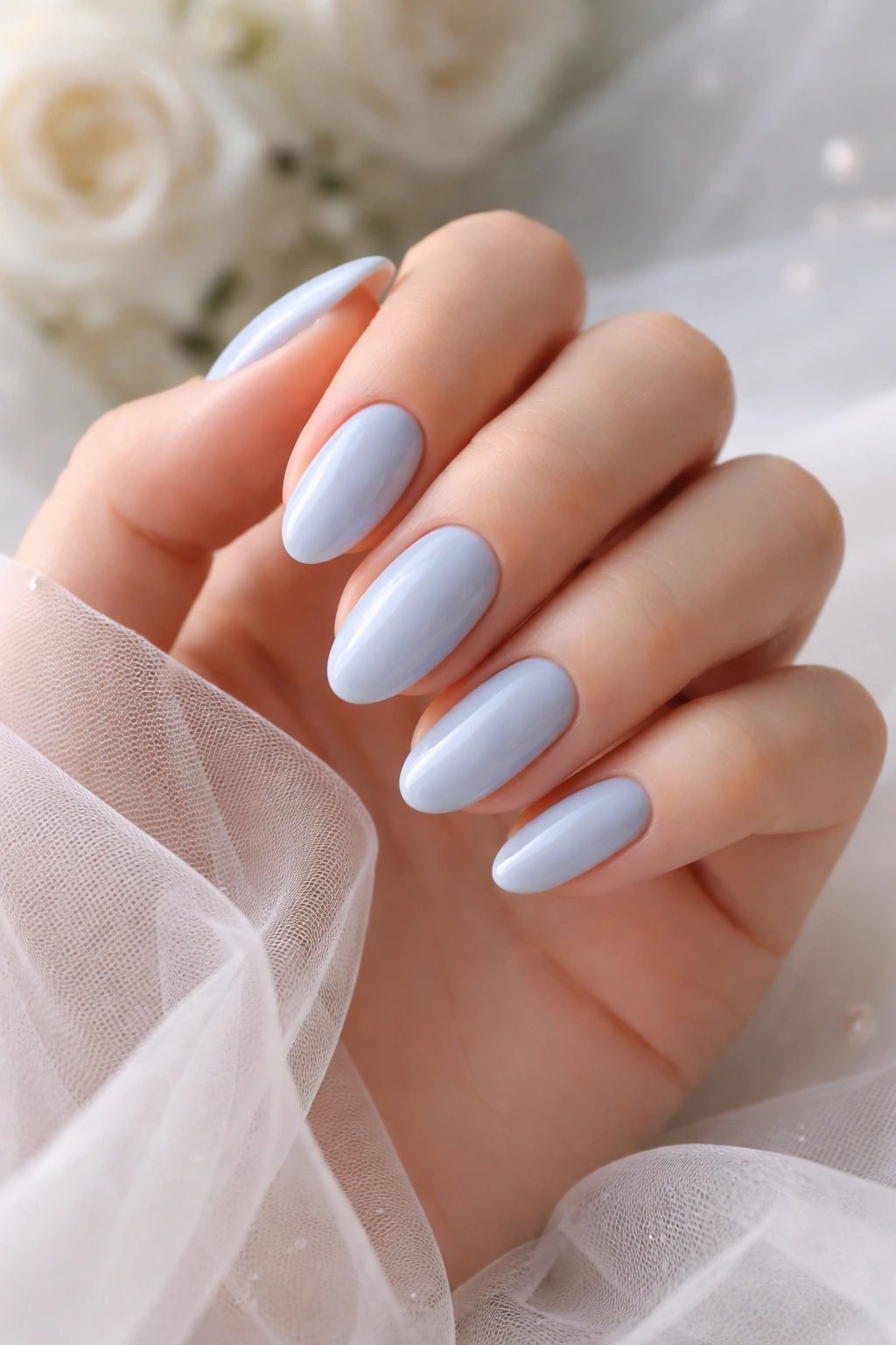 Close-up of baby blue wedding nails with soft, pastel finish