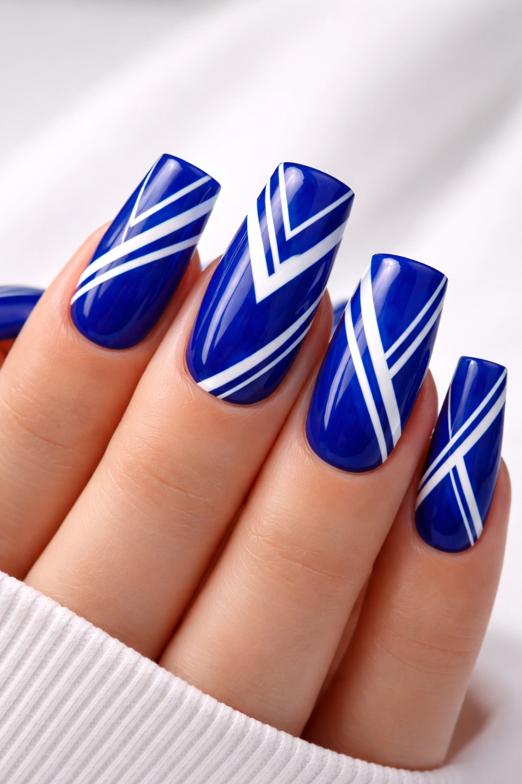 Duck nail featuring royal blue base with white geometric lines