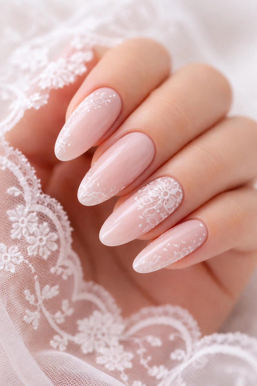 Soft blush nails with delicate white lace patterns
