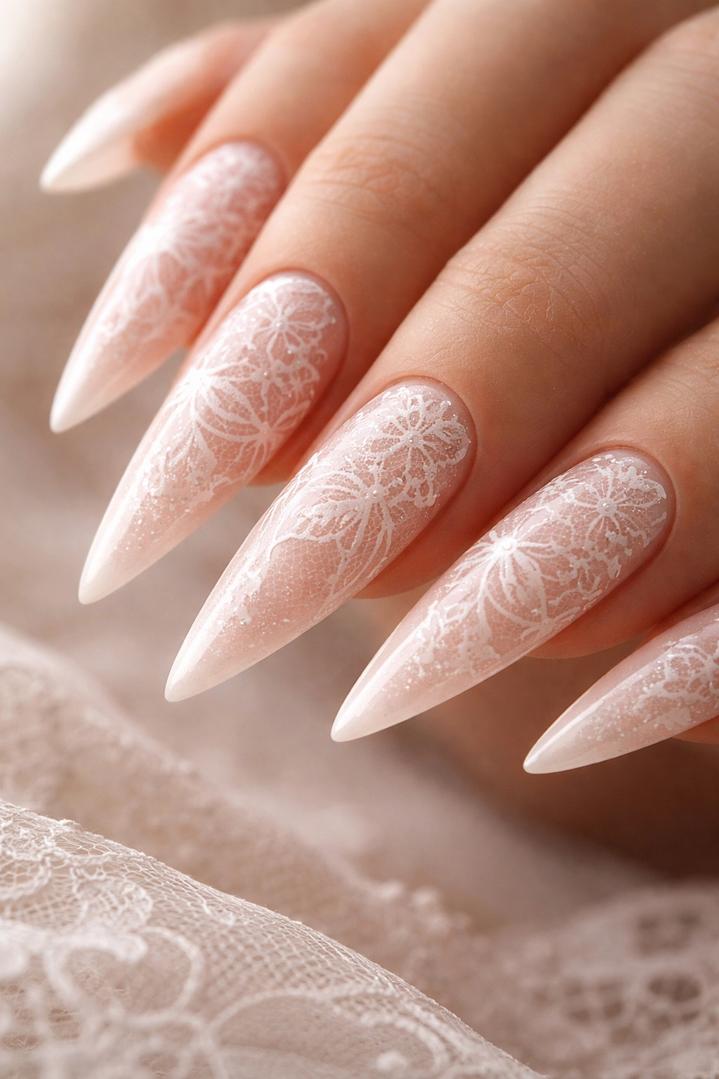 Blush pink stiletto nails with lace pattern