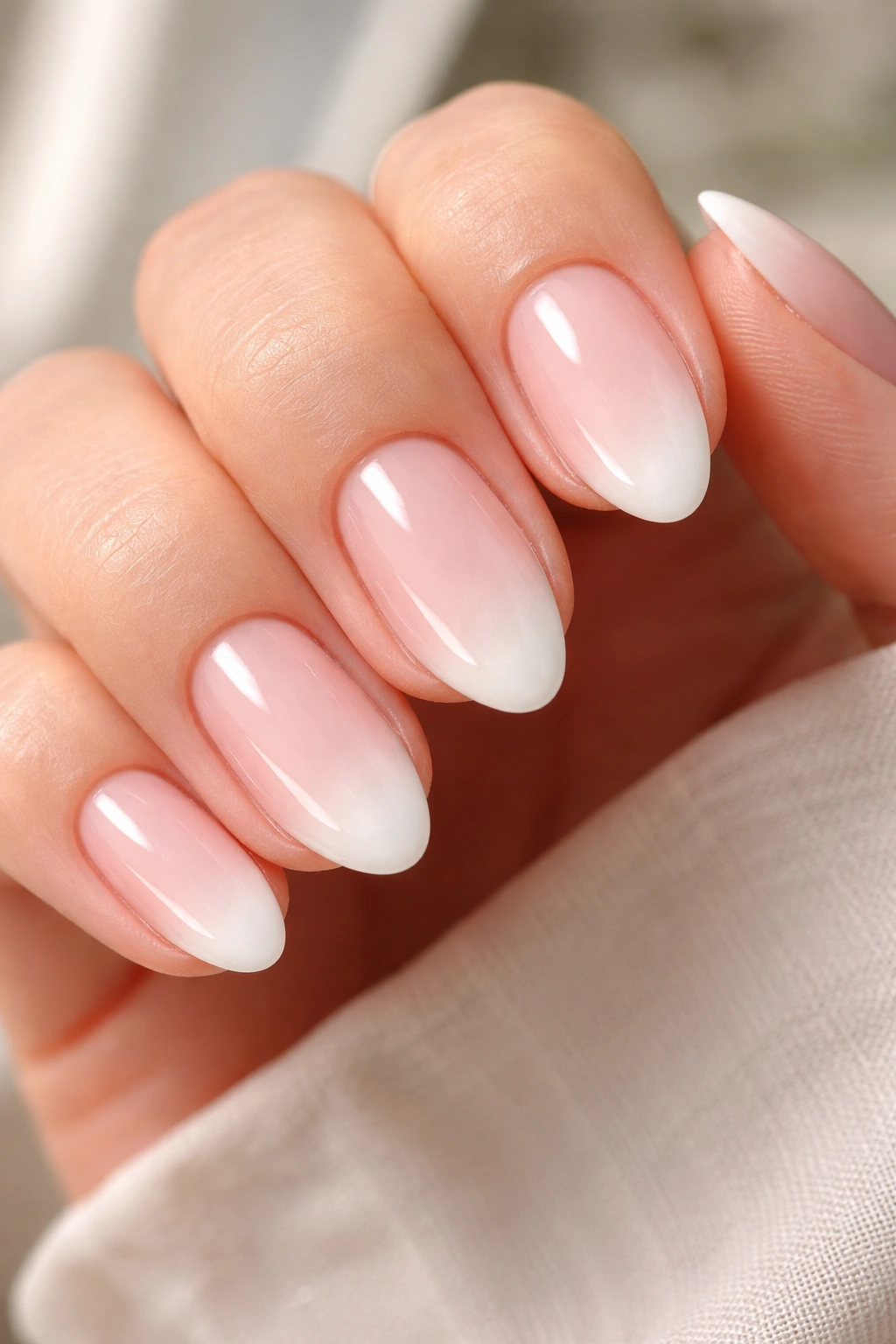 Short almond nails with sheer blush base and soft fade tips