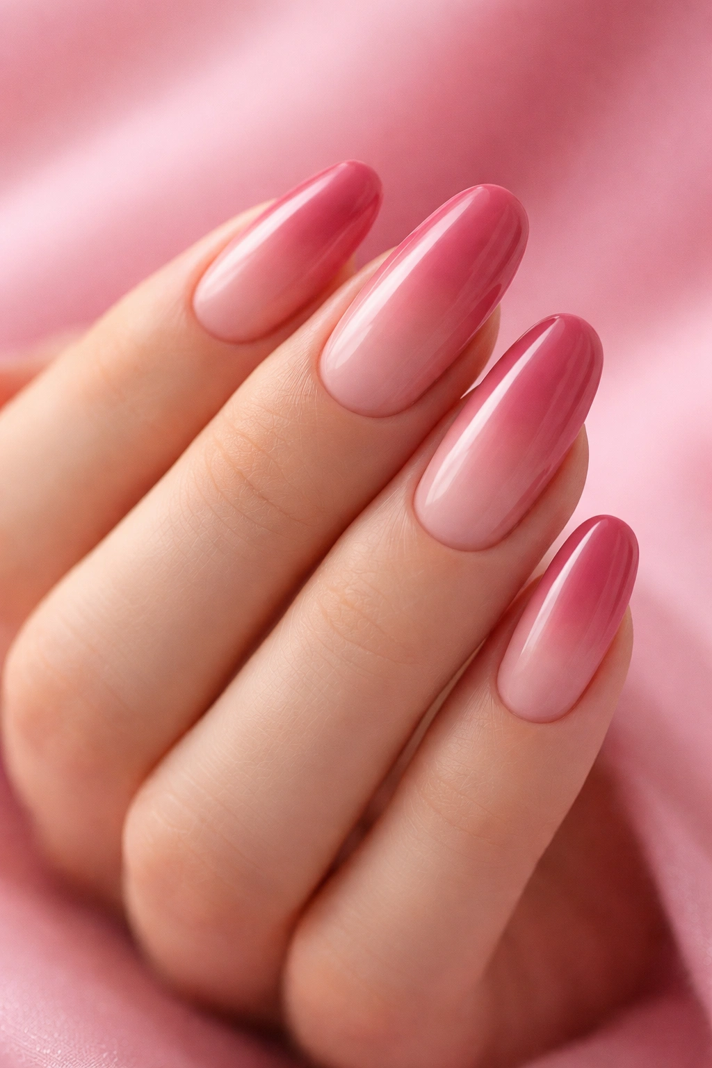 Close-up of blush to rose gradient on long round nails in a monochromatic pink manicure
