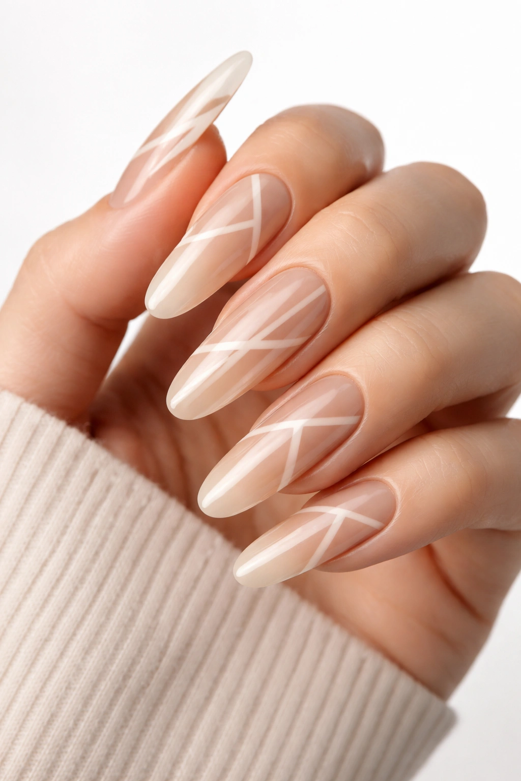 Close-up of bold nude nails with negative-space geometric design