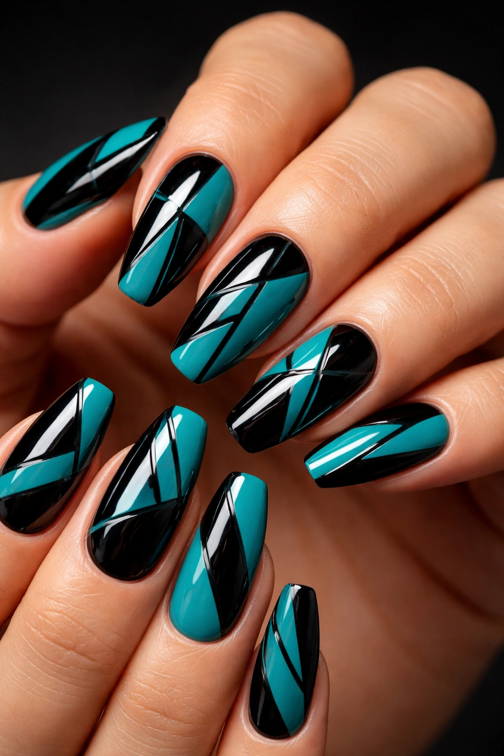 Close-up of bold teal and black geometric nails
