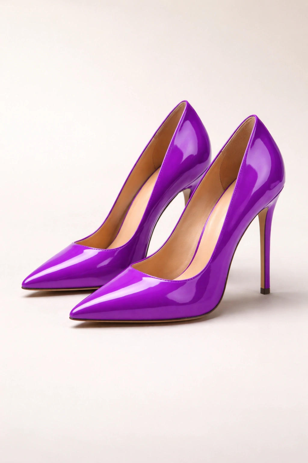Bright purple stilettos with glossy finish on neutral background