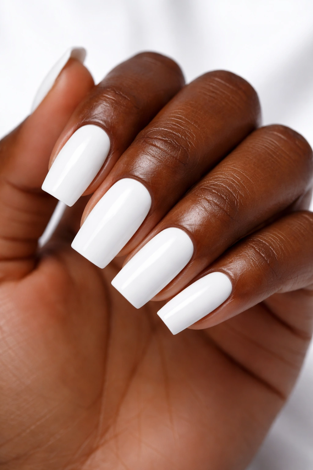 Dark skin with bright white nails