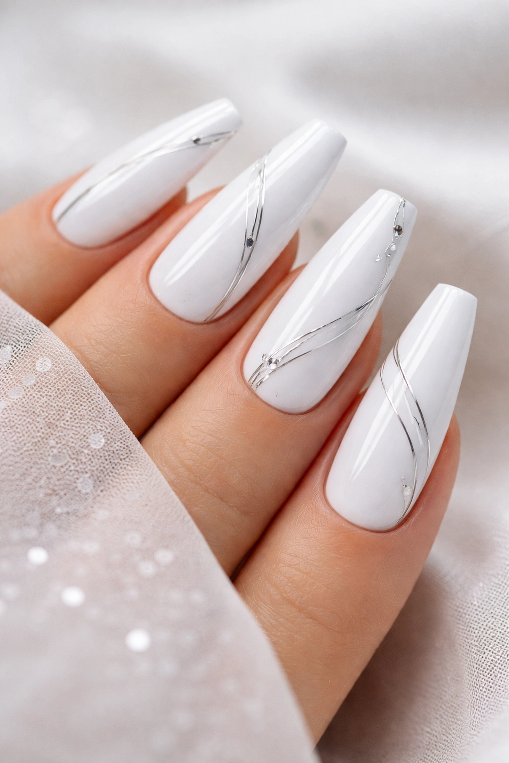 Coffin nails with bright white base and minimalist silver accents