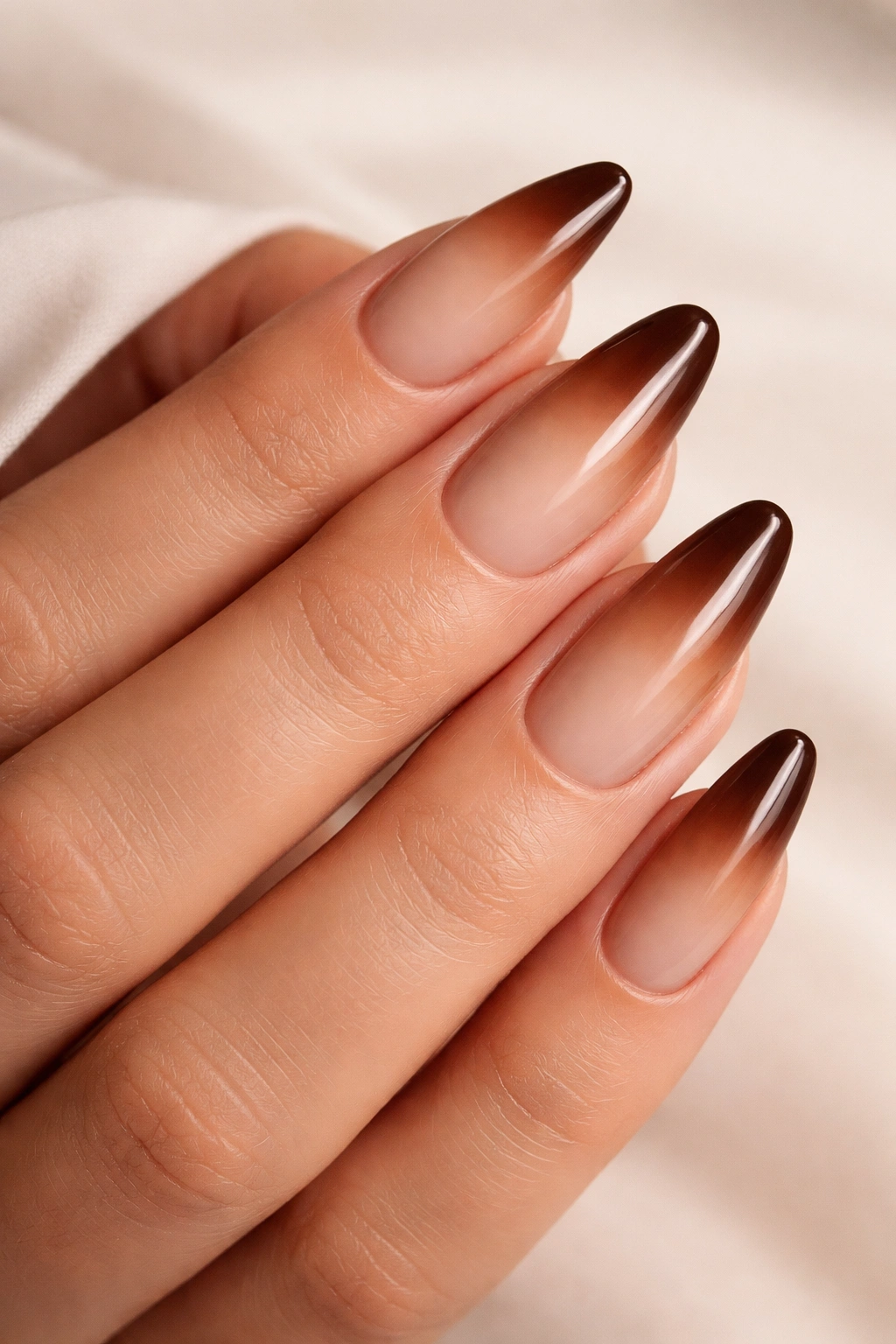 Nails with brown ombre French tips on almond shape