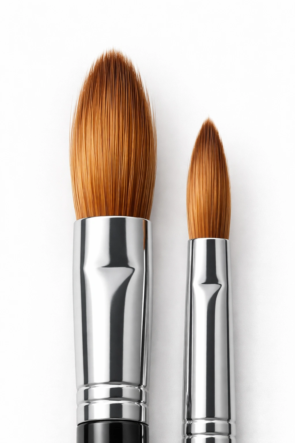 Close-up of two acrylic brushes showing size difference and bristle detail