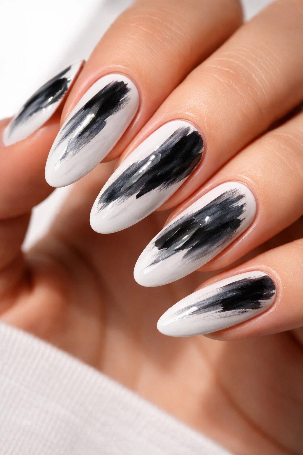 Long oval nails with abstract black and gray brushstrokes on white base