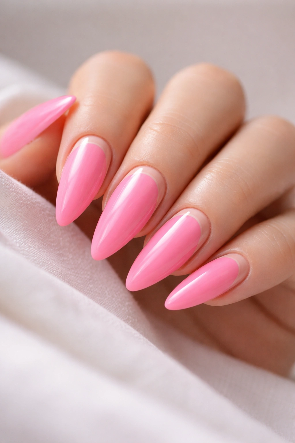 Close-up of bubble gum pink nails with nude reverse French line