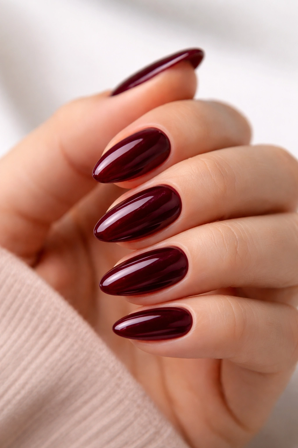 Short almond nails in deep burgundy high-gloss polish