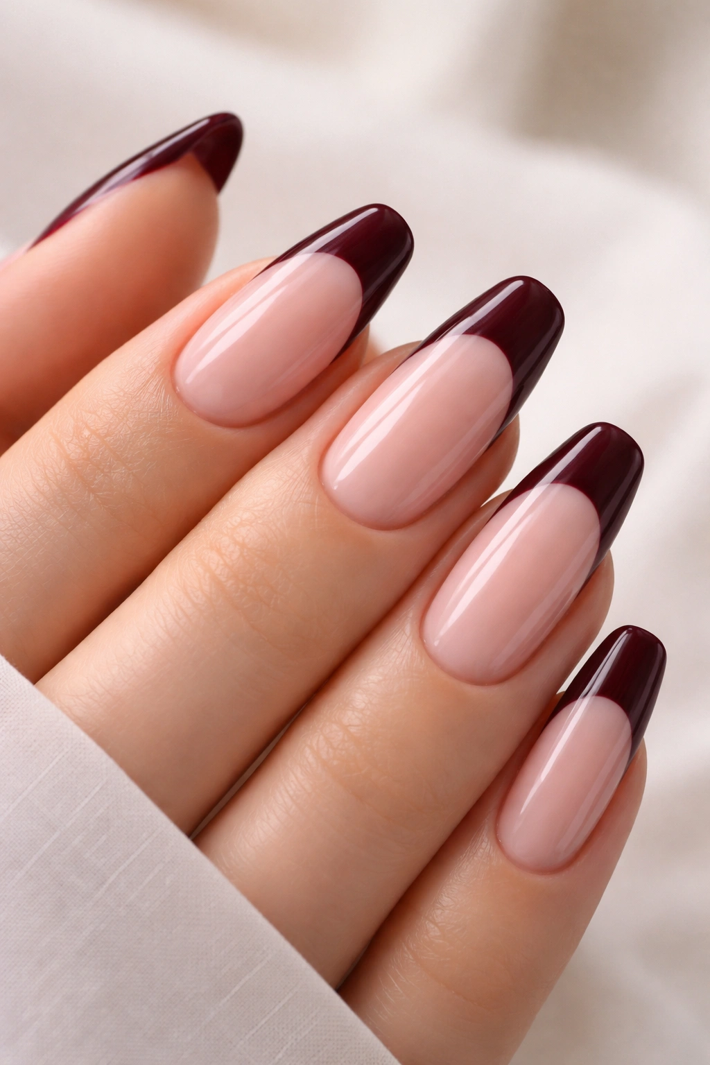 Nude base with burgundy French tips in wine tones