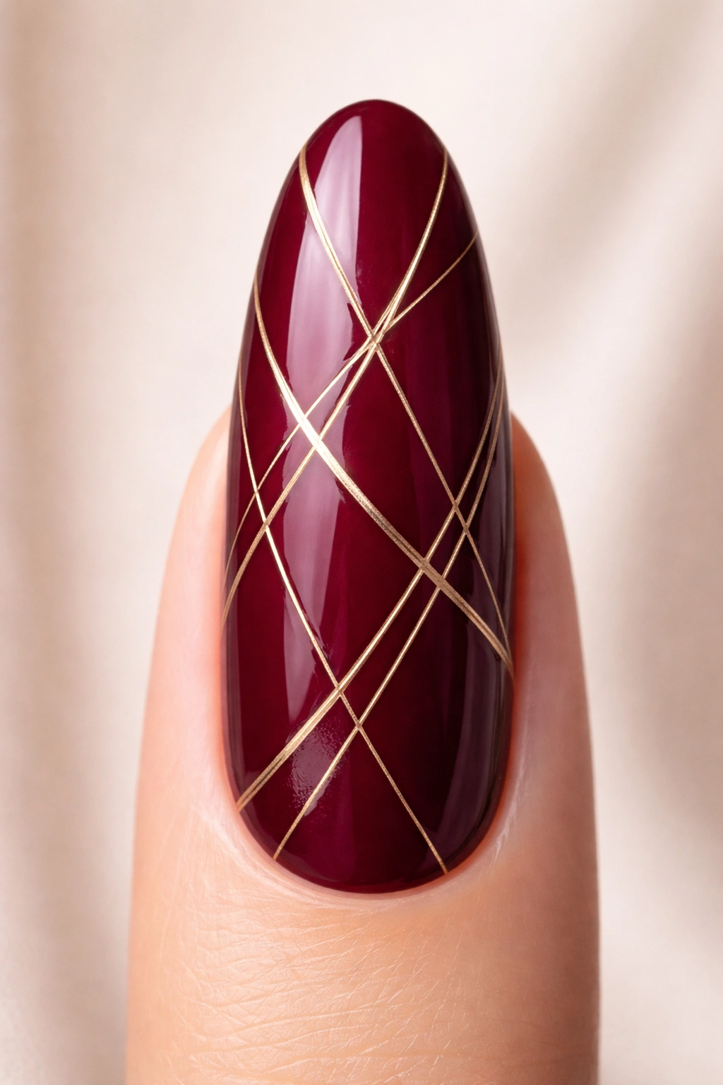Close-up of burgundy nail with geometric line art