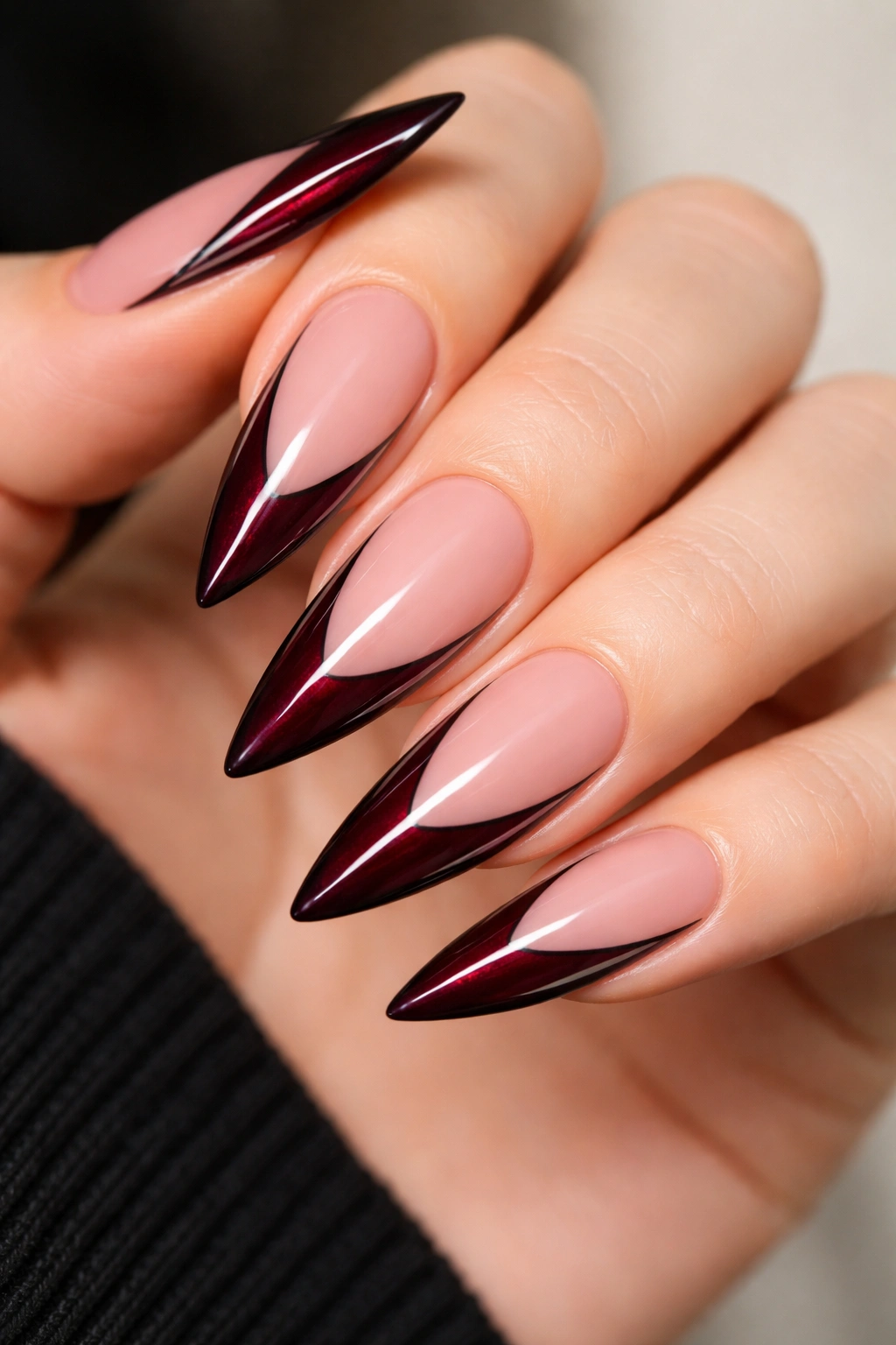 Nails with burgundy tips accented by thin black lines
