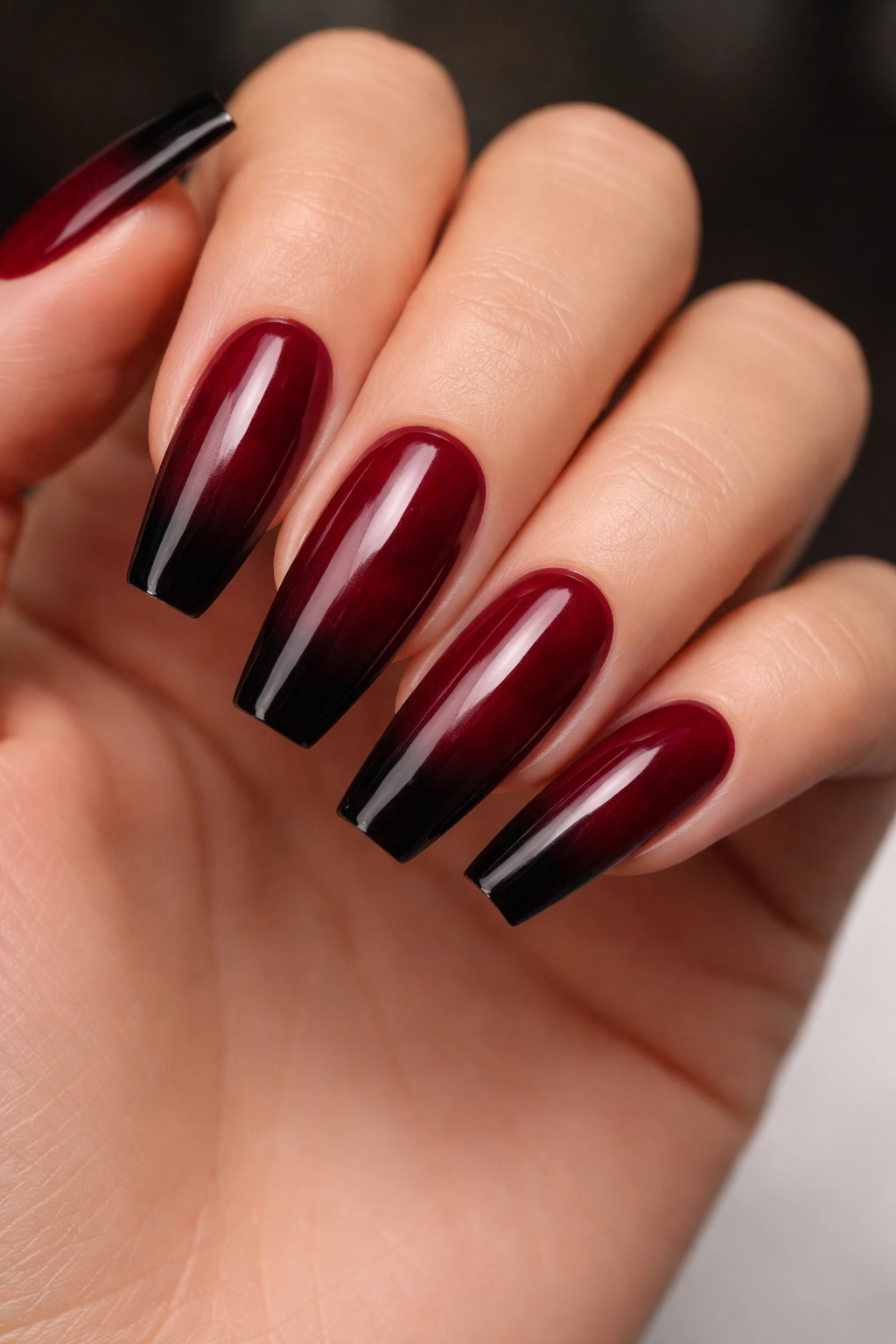 Burgundy coffin nails with black ombre tips.