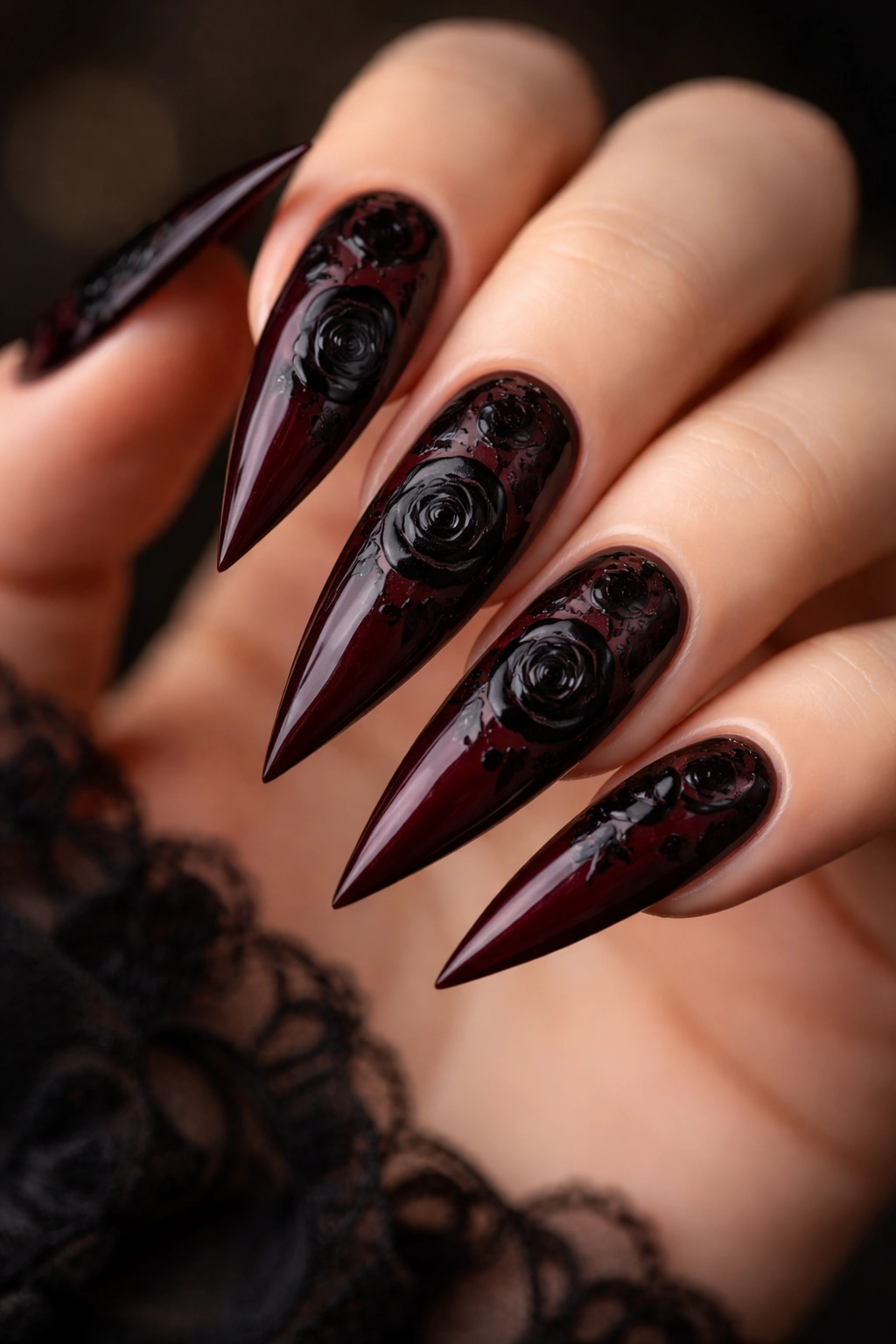 Deep burgundy nails with hand-painted black rose designs