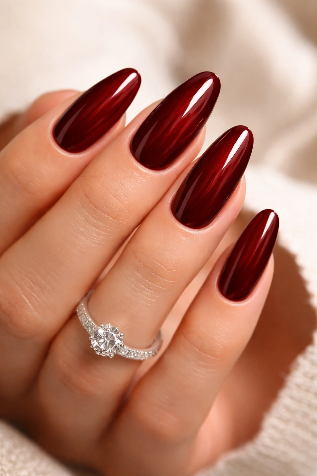Nails painted burgundy or deep red with glossy finish