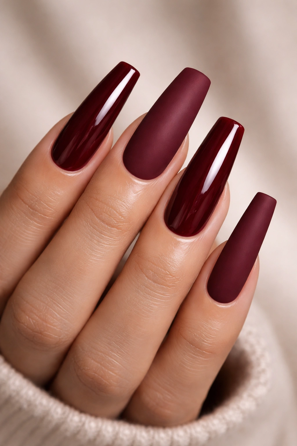 Long square burgundy nails with glossy and matte textures.