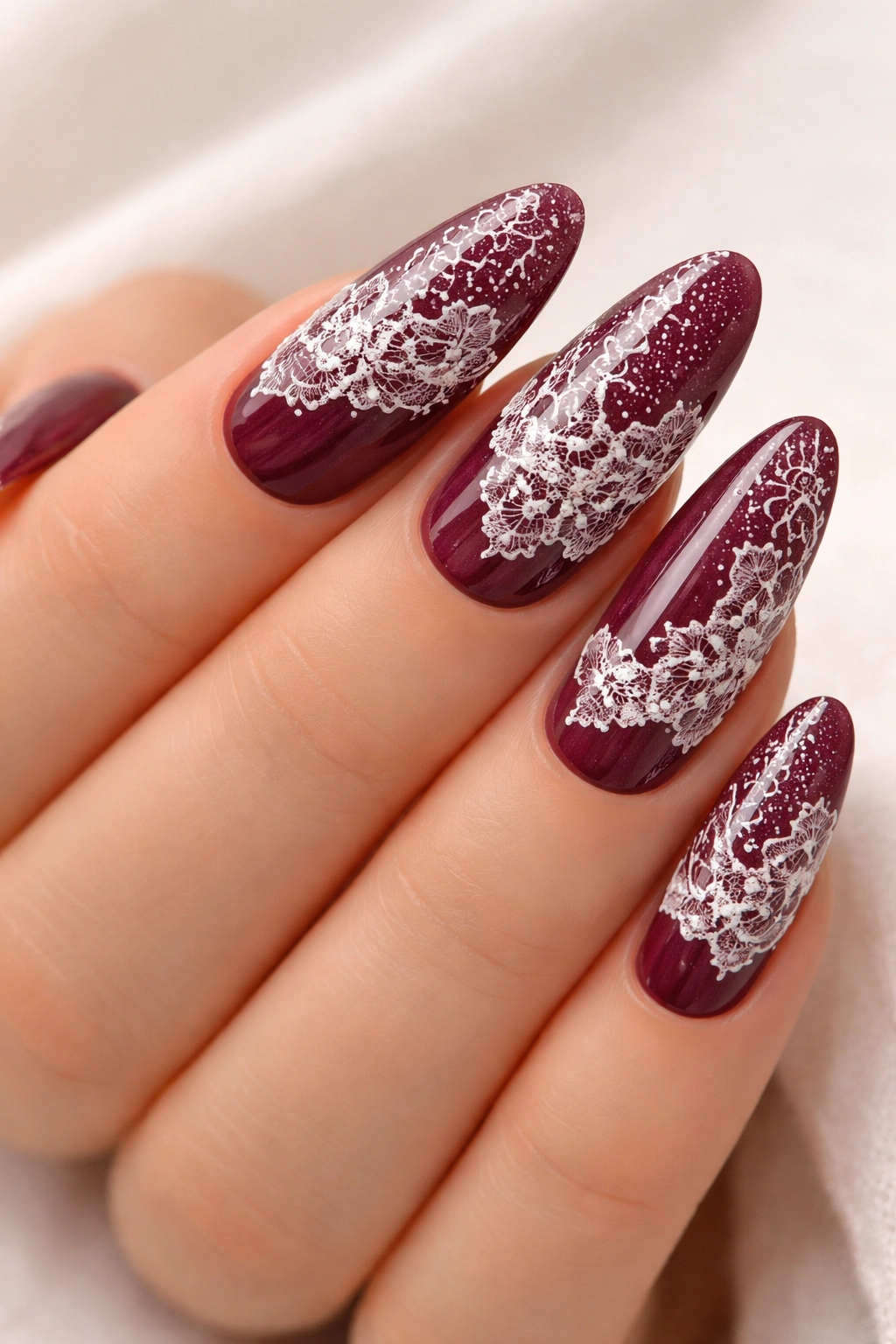 Burgundy nails with delicate white lace overlay