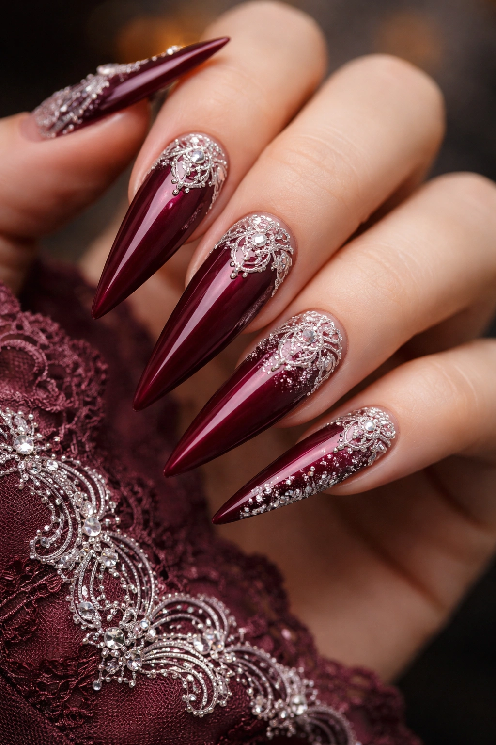 Burgundy nails with delicate lace and filigree patterns