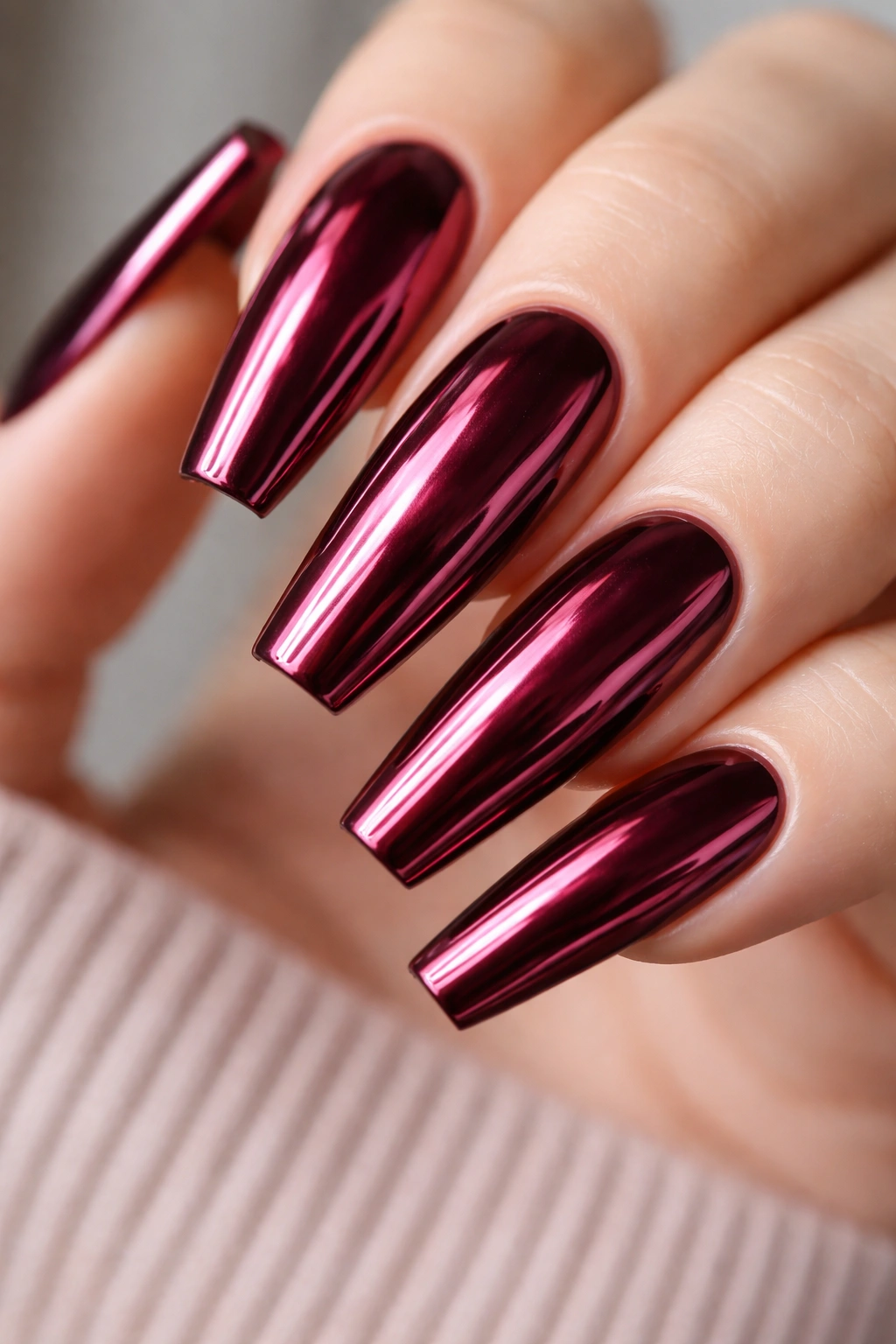Burgundy nails with a mirror finish reflecting the surroundings