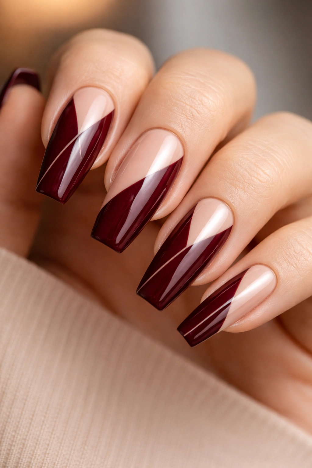Coffin nails with burgundy and negative space geometric patterns