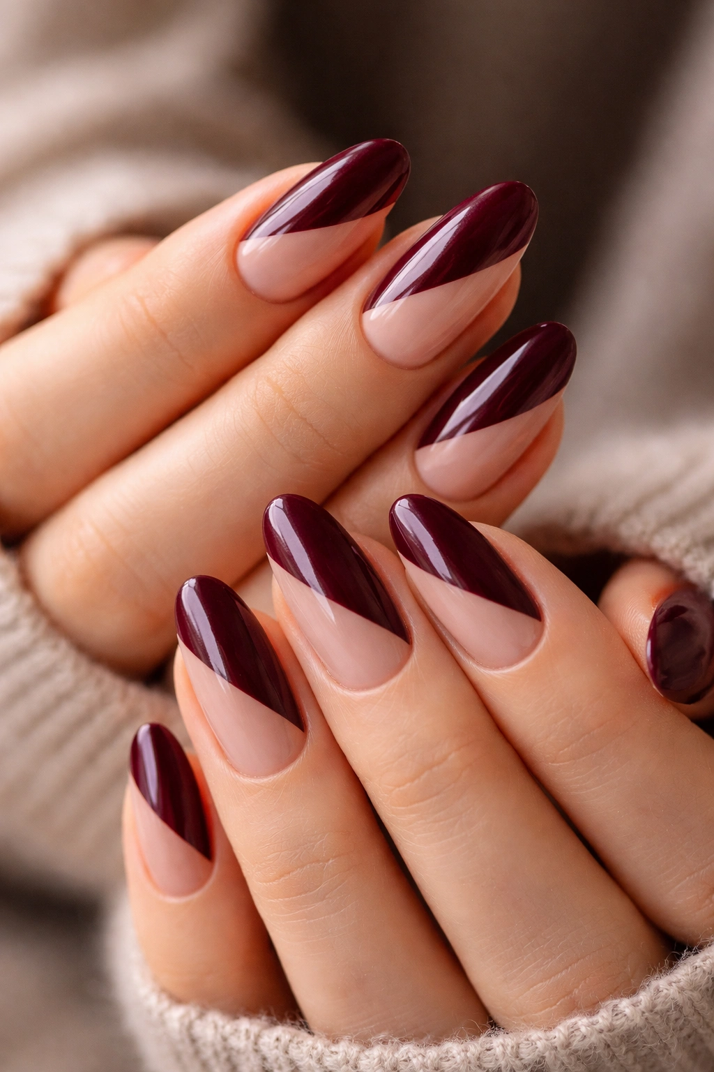 Close-up of long burgundy and nude split nails on hands