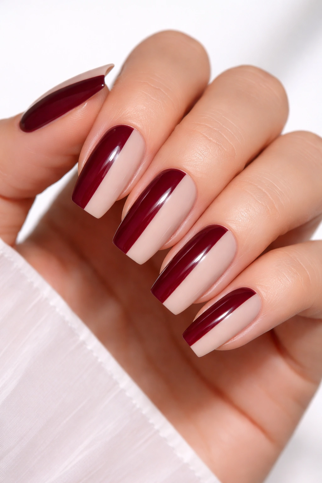 Two-tone burgundy and nude long rounded-square nails with a crisp split