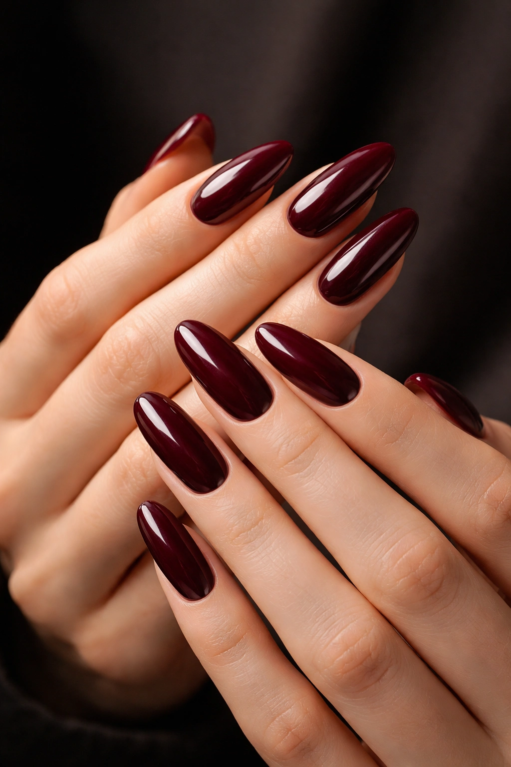 Long oval nails in deep burgundy with a cream finish