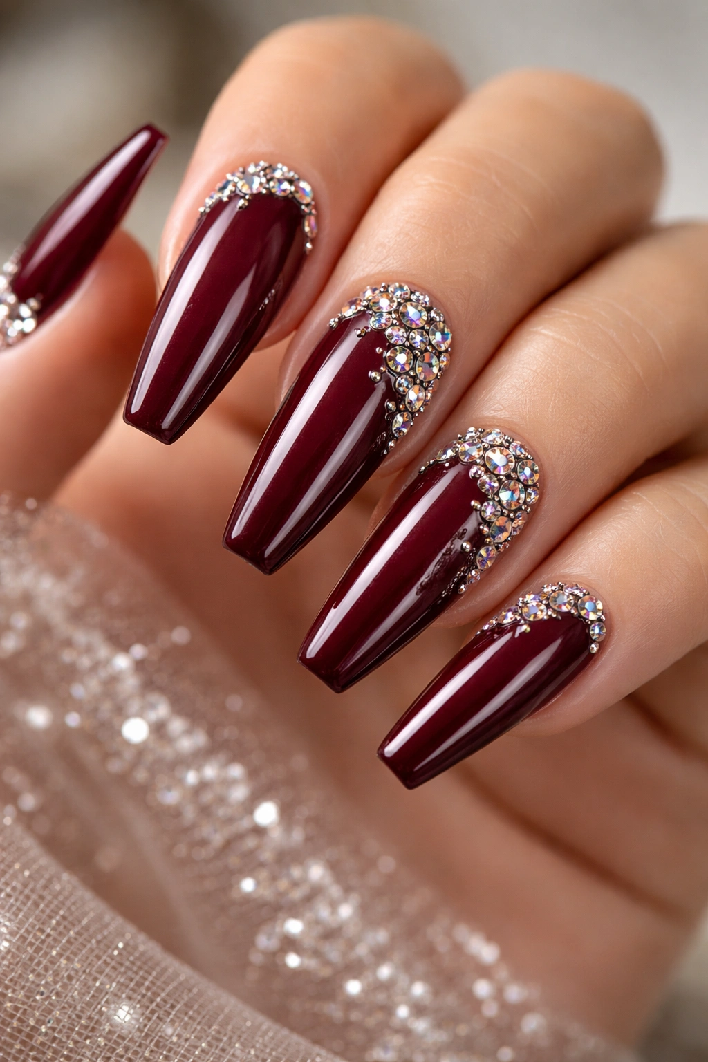 Burgundy nails with scattered rhinestones