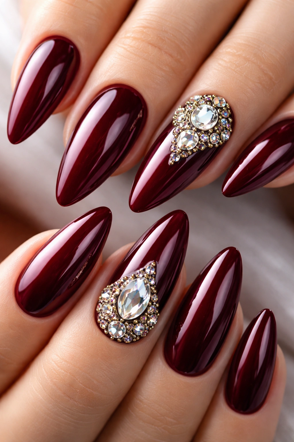 Burgundy nails with rhinestones gems on accent nails