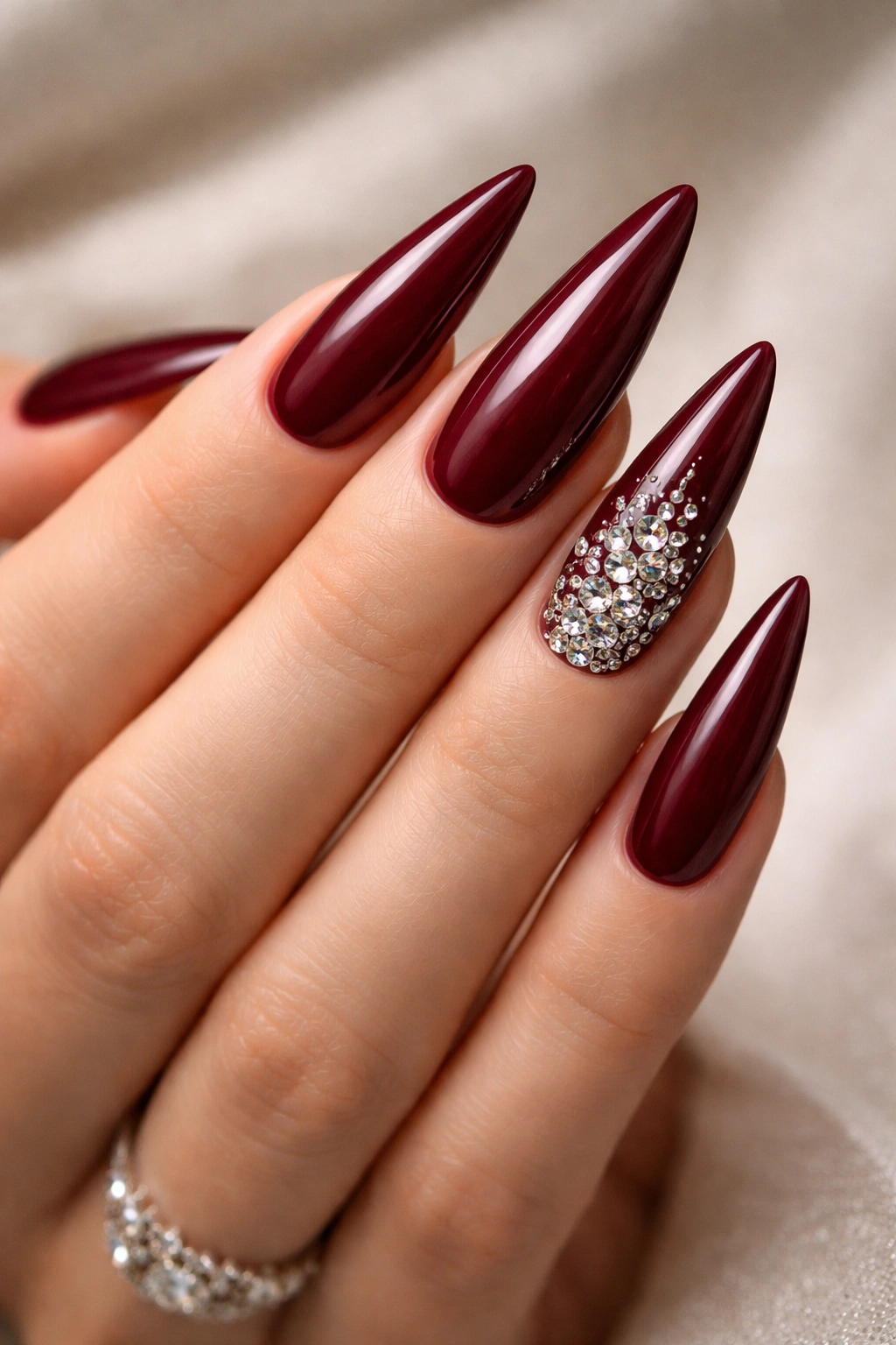 Burgundy nails with Swarovski crystal accents on accent nails
