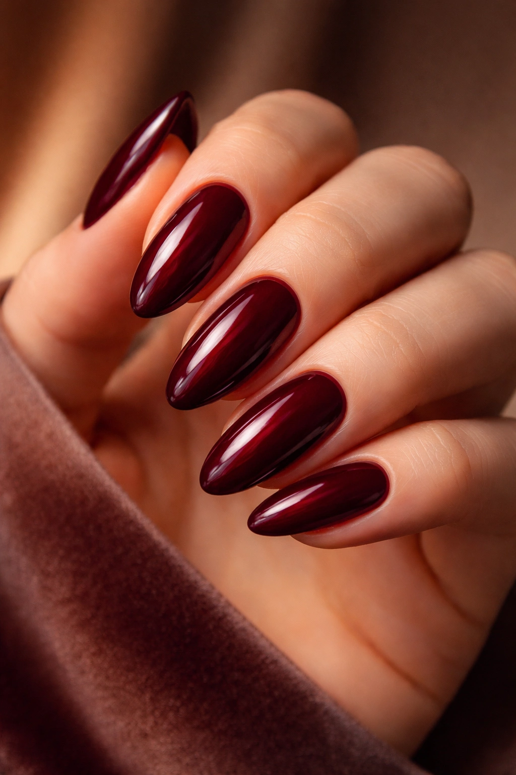 Close-up of deep burgundy nails with glossy finish