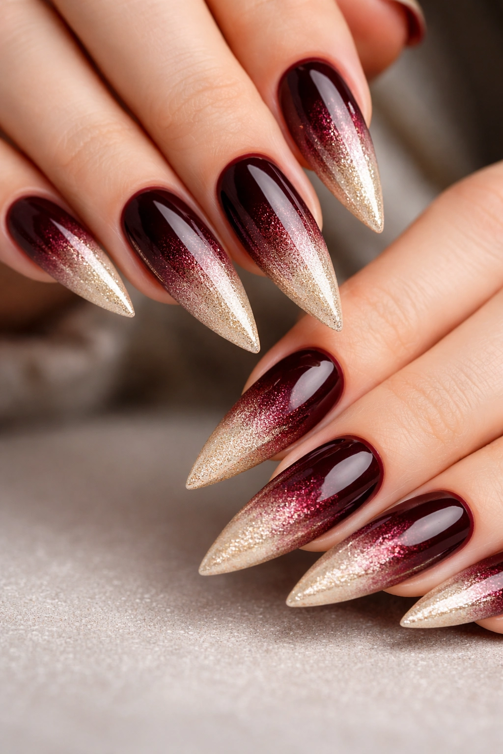 Stiletto nails with burgundy to champagne ombre