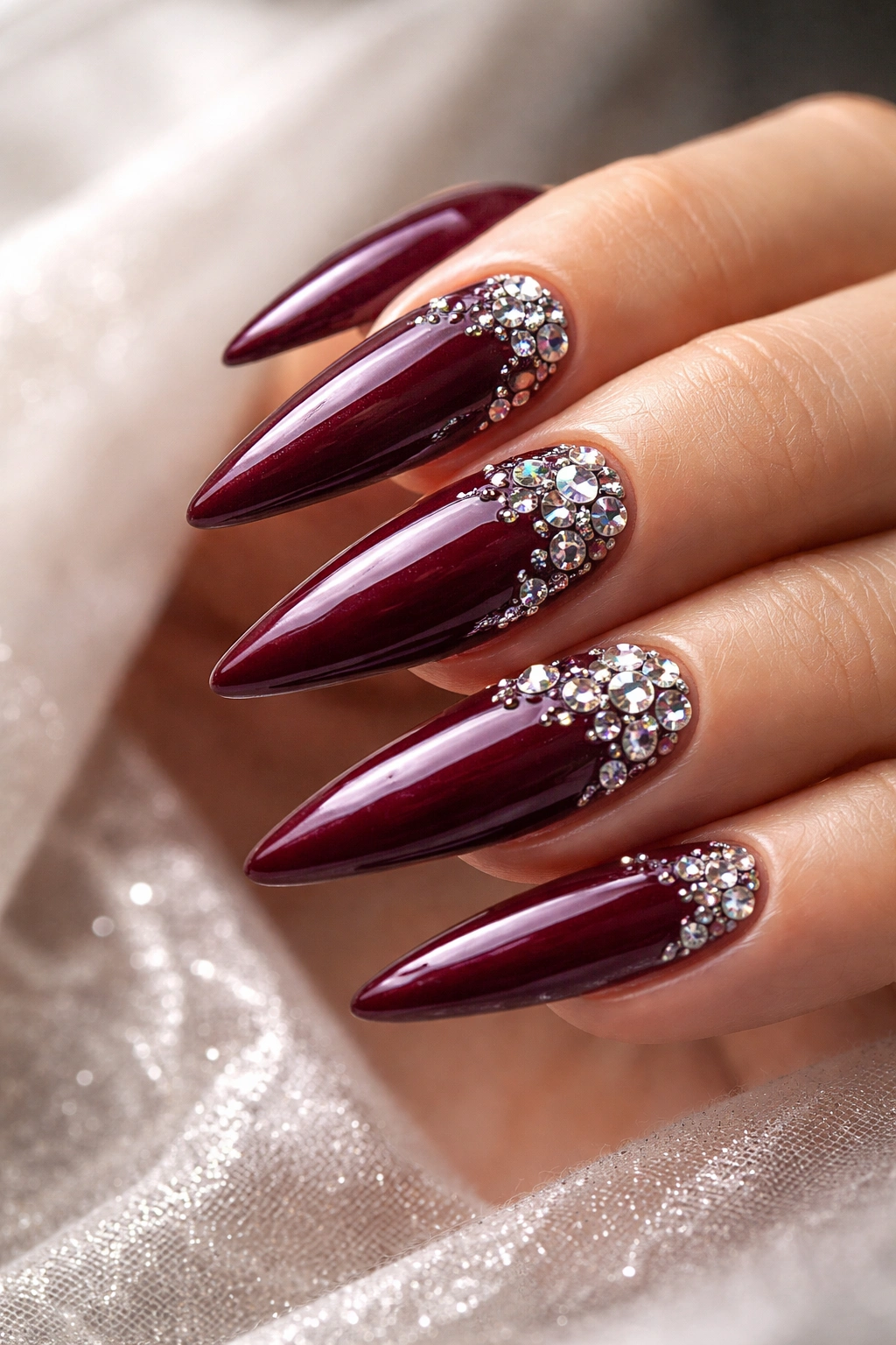Burgundy rhinestone nails with thick top coat for lasting wear
