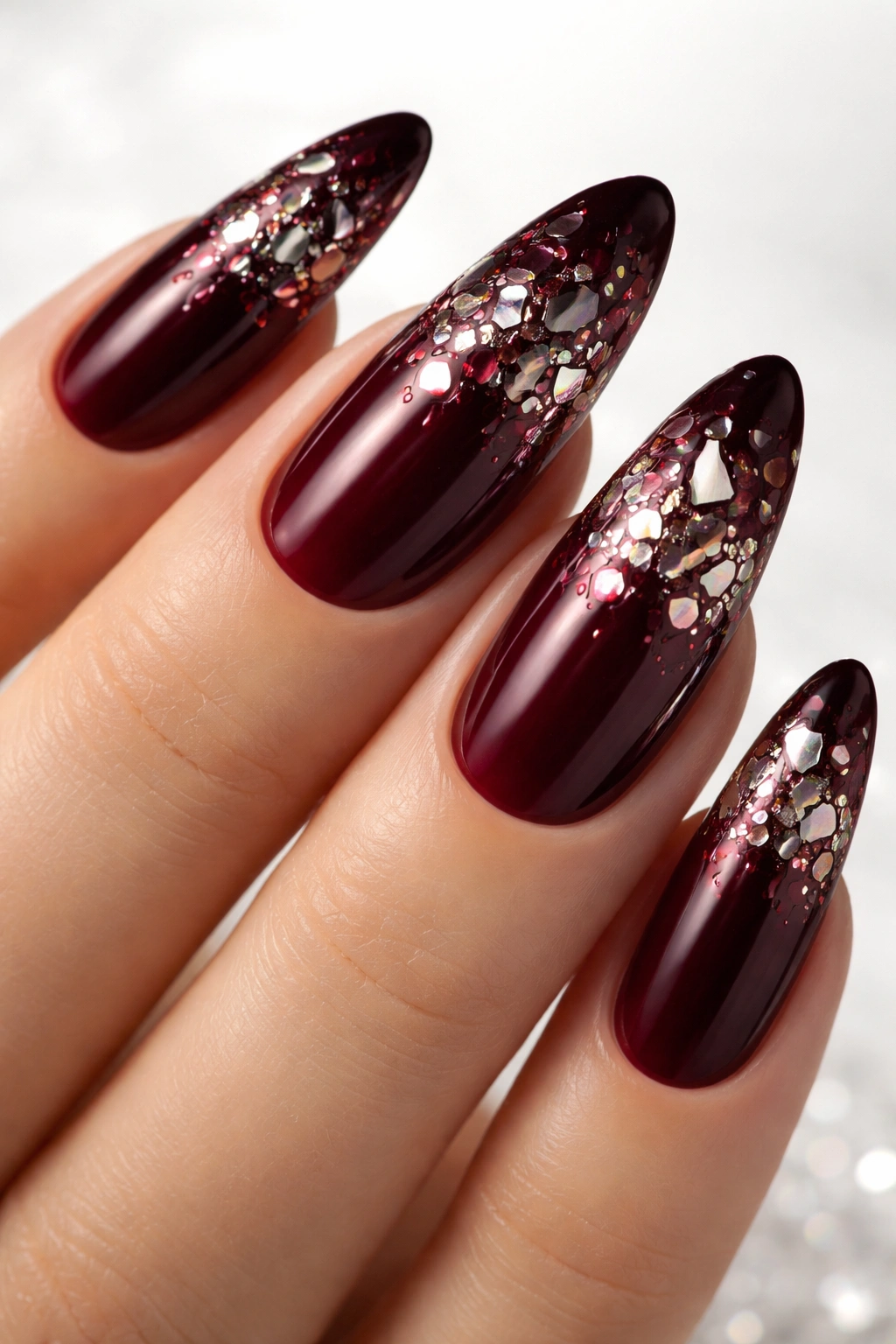 Close-up of burgundy nails with shattered glass effect