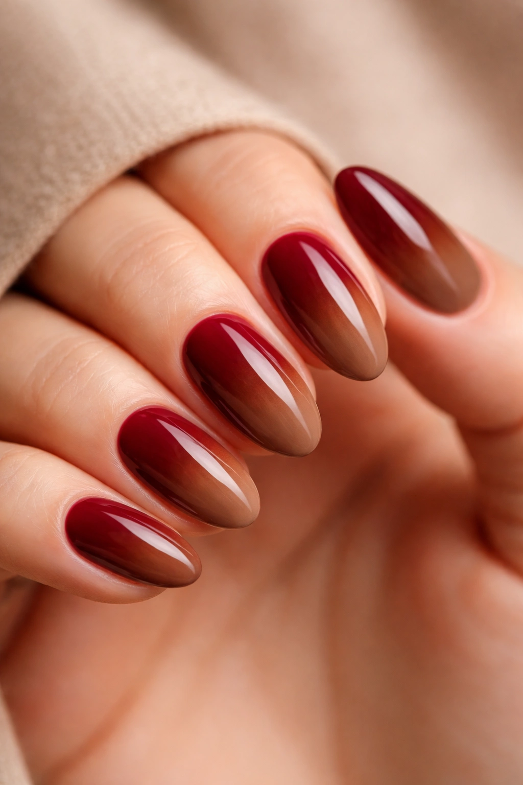 Walnut brown base with burgundy gradient on short almond nails.