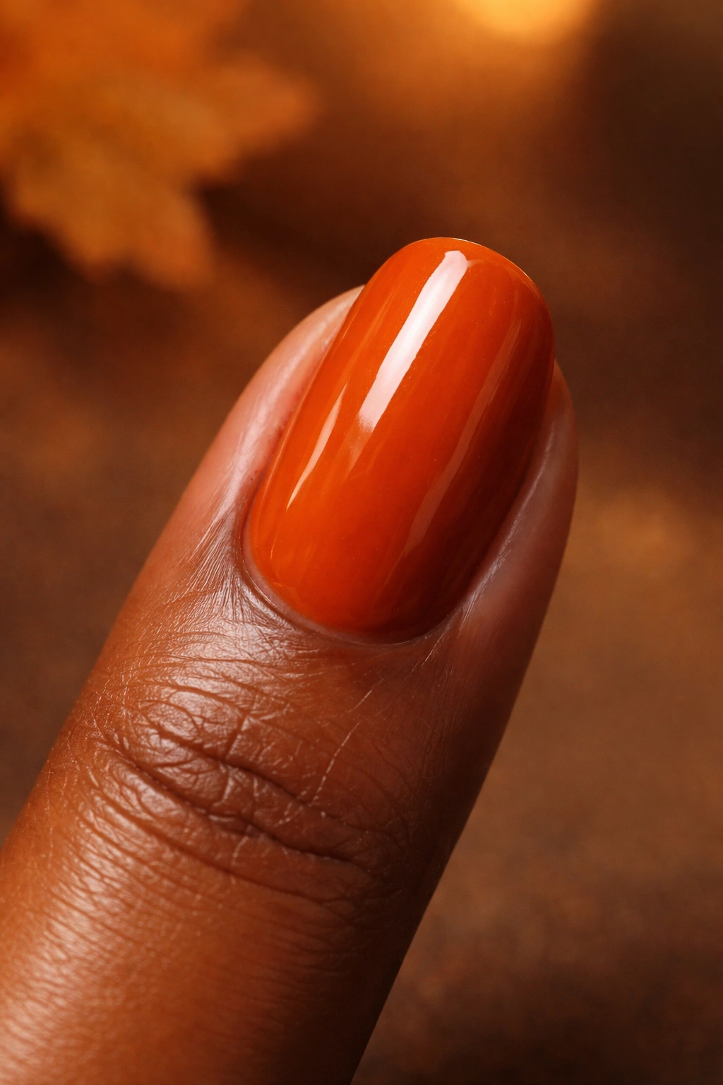 Burnt orange fingernail close-up