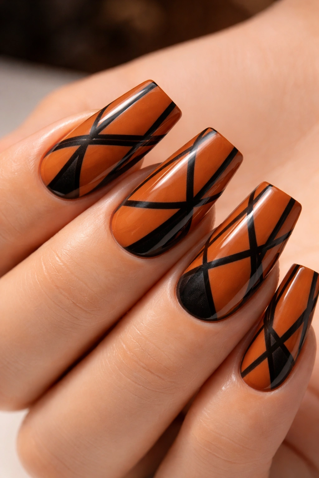 Burnt orange nails with geometric black lines