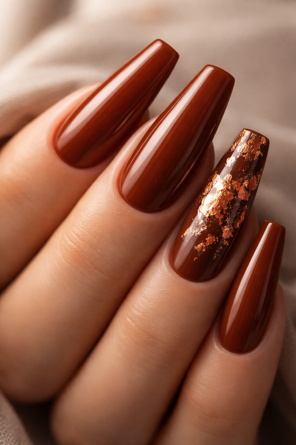 Burnt sienna coffin nails with copper leaf accents on selected nails