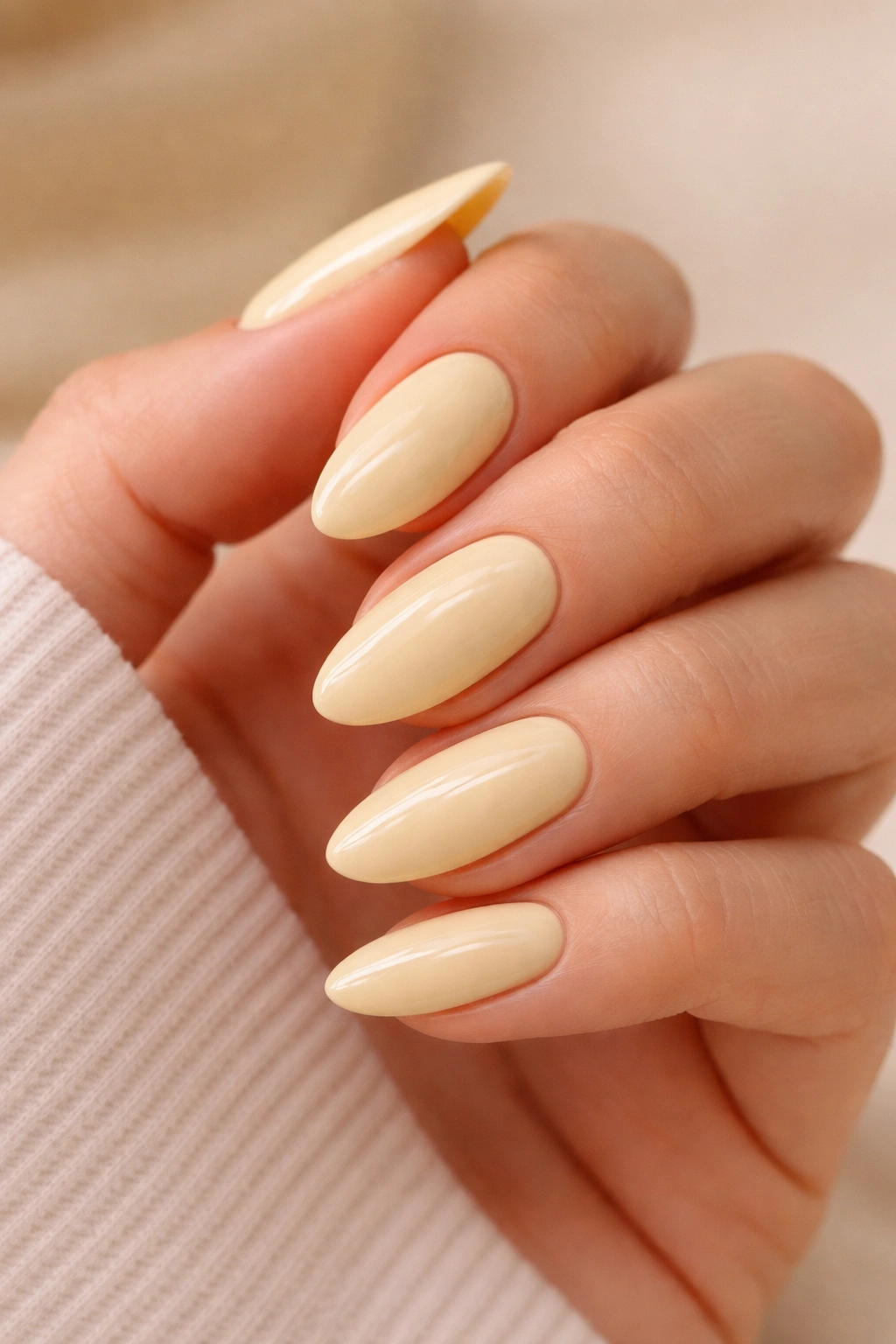 Almond nails in soft butter-yellow with creamy finish and gloss