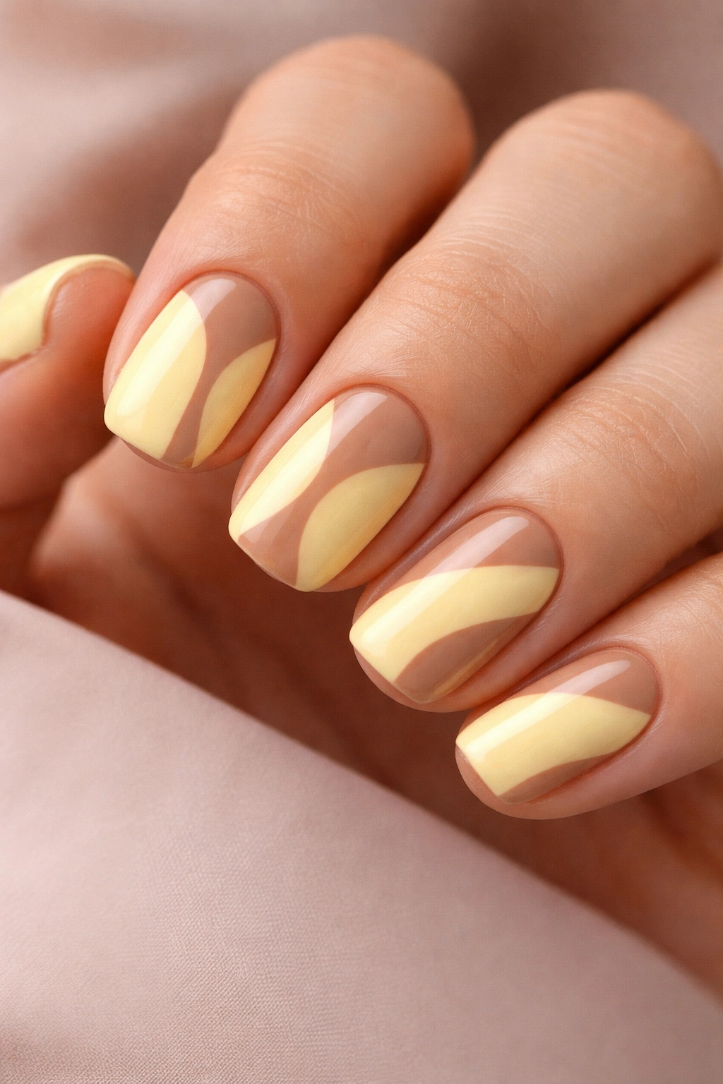 Close-up of nails with soft brown negative space on butter yellow