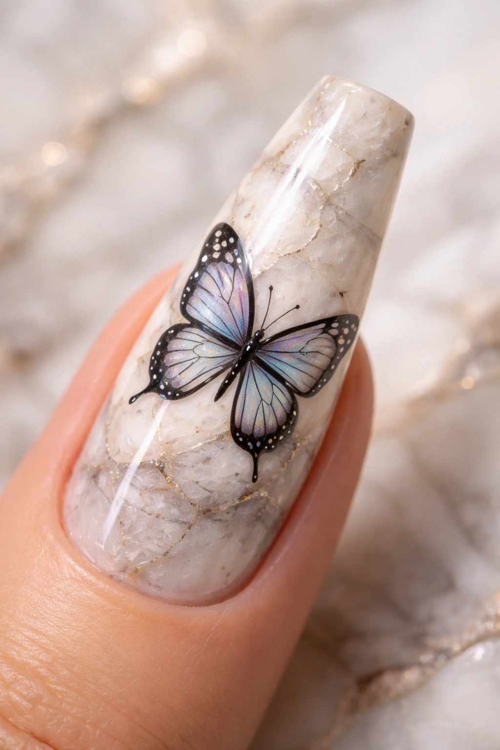 Close-up of coffin nails with a marble base and a butterfly motif on top.