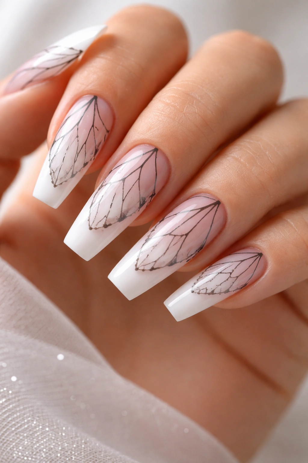 Close-up of coffin nails with gradient base and delicate black butterfly line art.