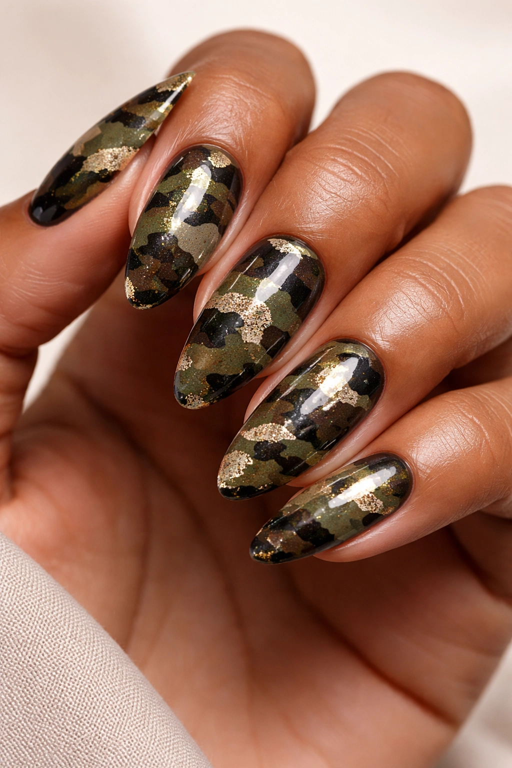 Camo patterned nails with greens and browns with gold glitter
