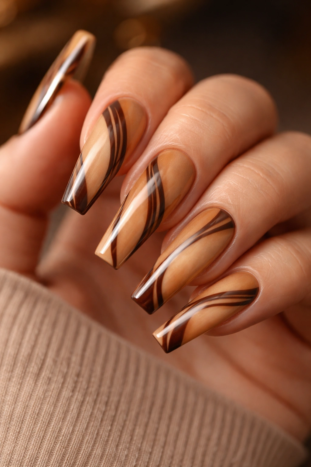 Caramel nails with dark chocolate stripes.