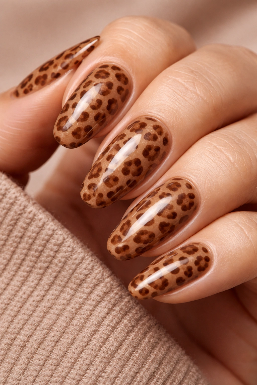 Close-up of caramel nails with tonal brown leopard print.